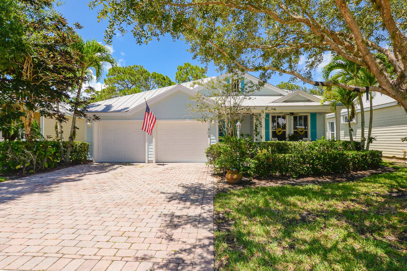 Step into the sun drenched serenity of this Key West style gem at 608 NE Canoe Park Circle in the renowned River Place community of Port St.