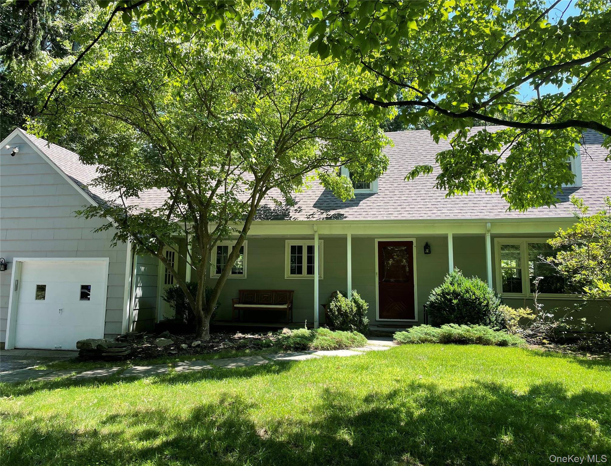Charming, sunny Windmill Farm Cape Cod across from North Lake in natural setting with seasonal lake views, welcoming front porch, patio with year around North Lake views, hardwood floors, energy ...