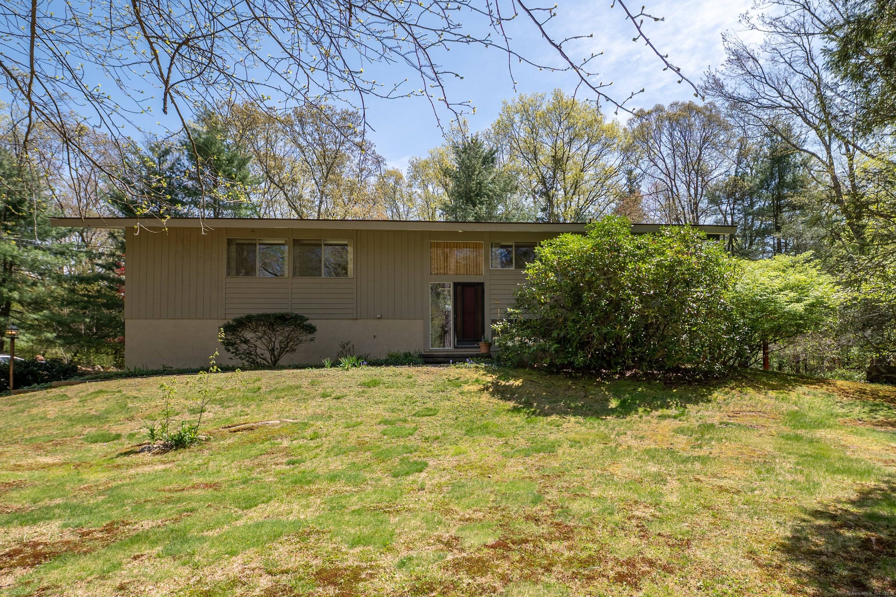 Beautiful level 1. 5 acres surround this Mid Century Modern home, built in 1968.
