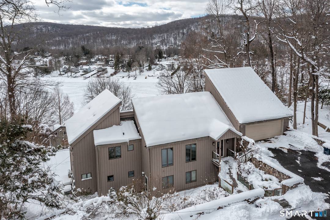 Perched high in the sought after Bogus Hill community, this extraordinary lakeview retreat captures breathtaking west facing sunsets over Candlewood Lake from two expansive decks designed for unforgettable entertaining.