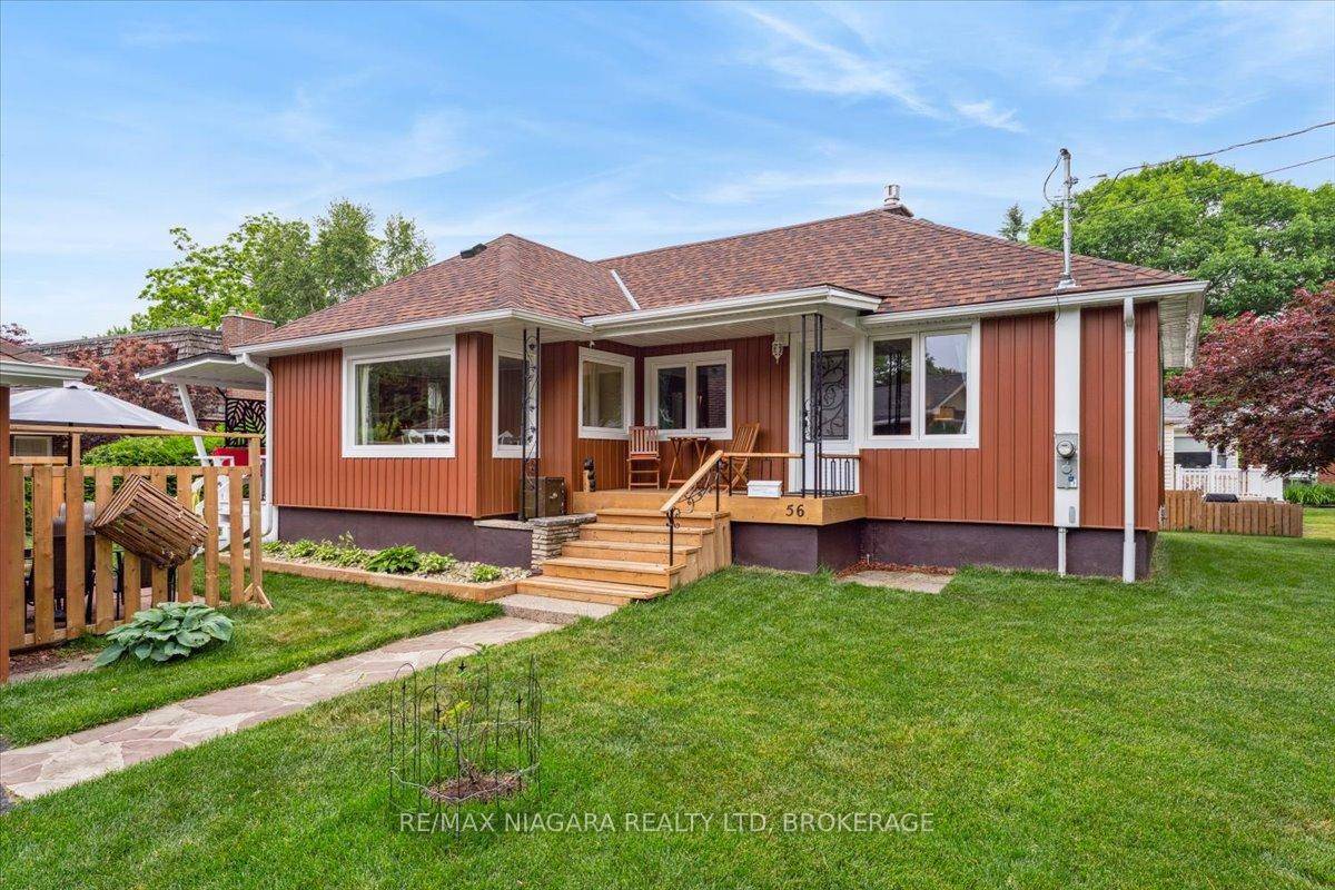 NESTLED ON A BEAUTIFUL TREE LINED STREET, THIS CHARMING TWO BEDROOM HOME OFFERS A GLIMPSE OF THE LAKE.