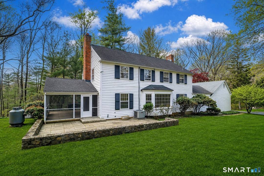 Perched gracefully atop a scenic hill, this quintessential Connecticut home offers a rare blend of privacy, charm, and opportunity.
