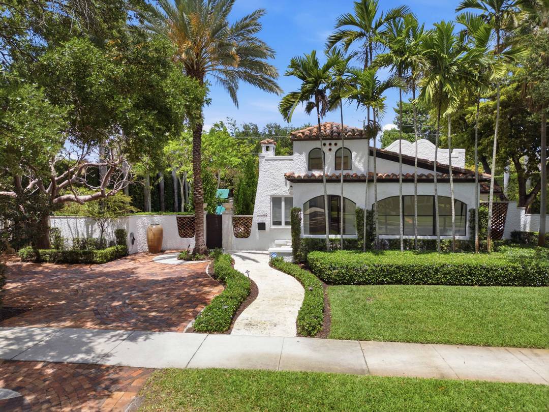 Experience the rare allure of this Spanish Revival masterpiece, situated on an expansive triple lot for ultimate privacy.