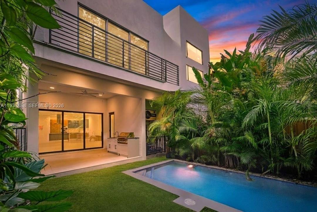 Tucked behind a private gate on a quiet Coconut Grove street, this 2022 contemporary townhome delivers architectural edge with effortless luxury tropical living.