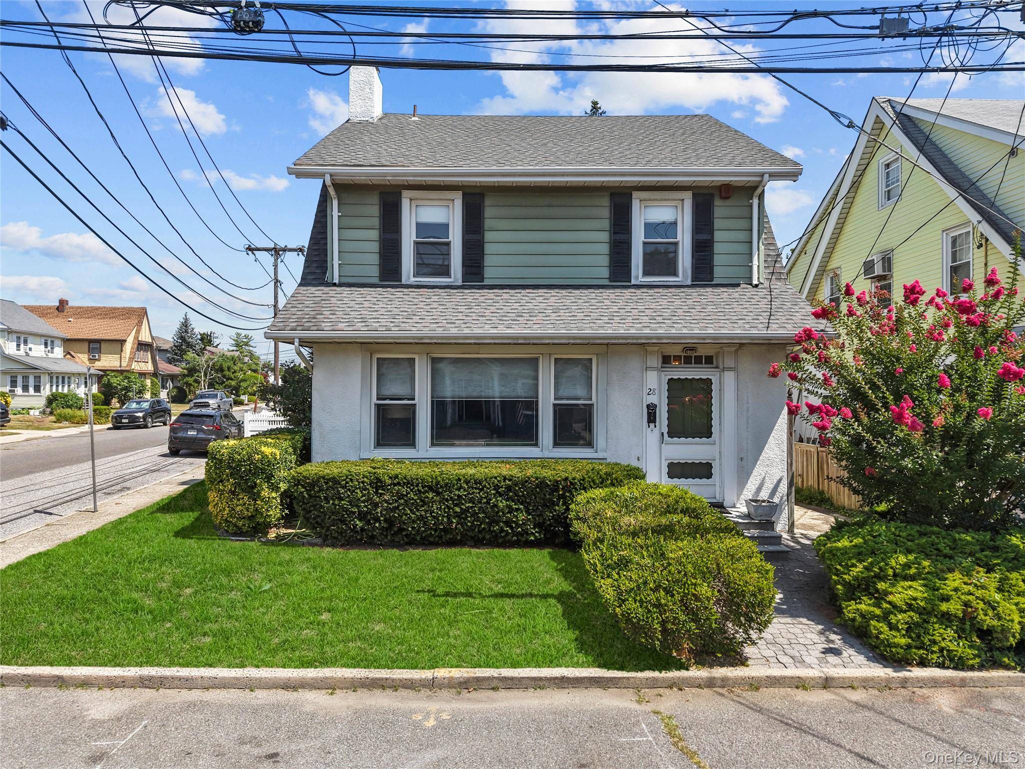 Welcome to 28 Crescent Street, a classic side hall Colonial style home nestled in Hewlett s esteemed School District 14.