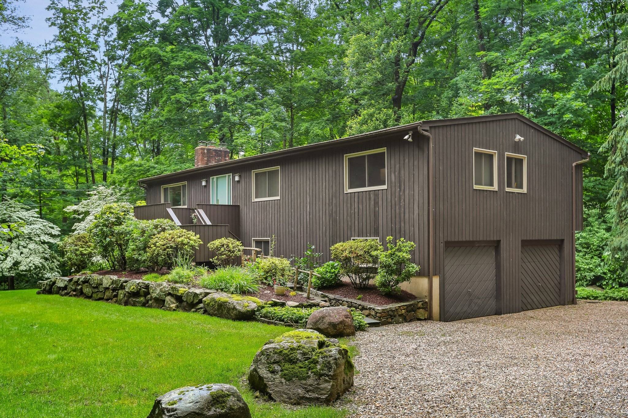 Experience gracious living in this 5 bed, 3 bath Mattera built contemporary high ranch on a sprawling one acre lot adorned with mature landscaping and captivating rock outcroppings.