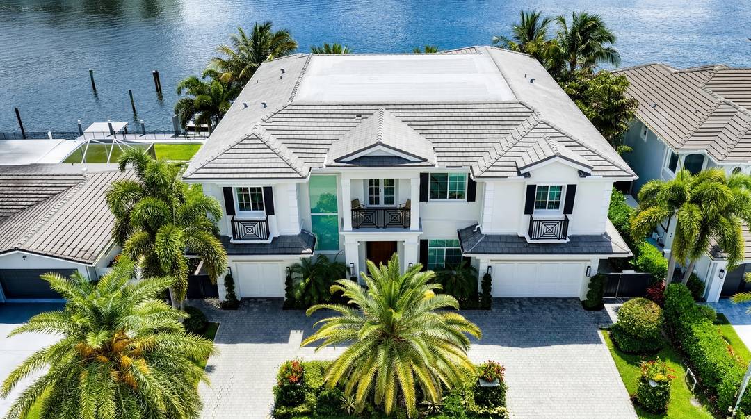 Beautiful landscaping sets the tone for this magnificent waterfront estate in Boca Harbour Island, imparting a luxuriant sense of place, while the rear gardens offer resort style outdoor living.