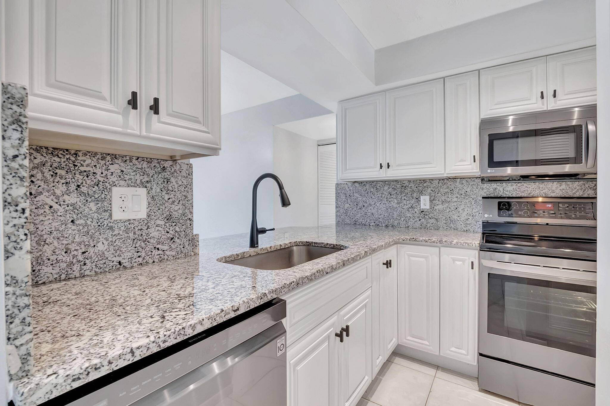 The kitchen has been UPDATED and the private screened balcony features a beautiful LAKE VIEW.