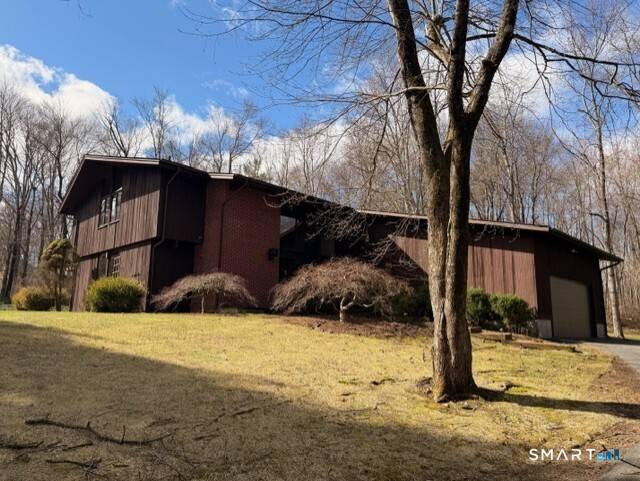 Nestled in a serene, park like setting in the highly sought after Codfish Hill neighborhood of Bethel, this exceptional property offers the ultimate retreat for nature lovers.