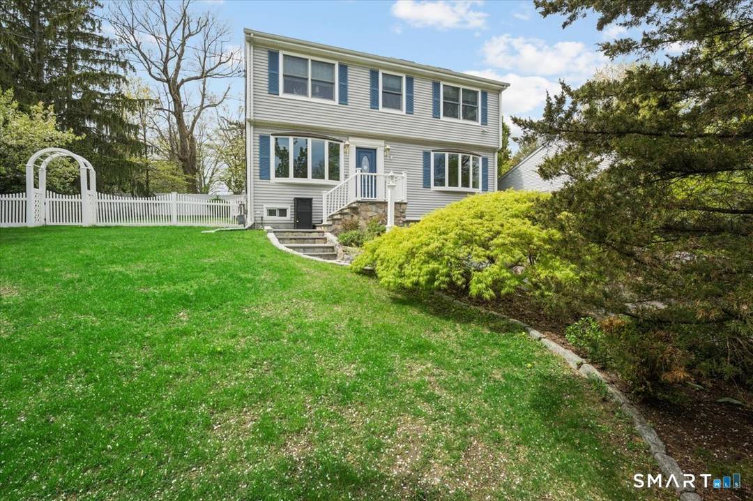 This immaculate updated colonial home features a beautifully landscaped yard and an oversized 4 car garage.
