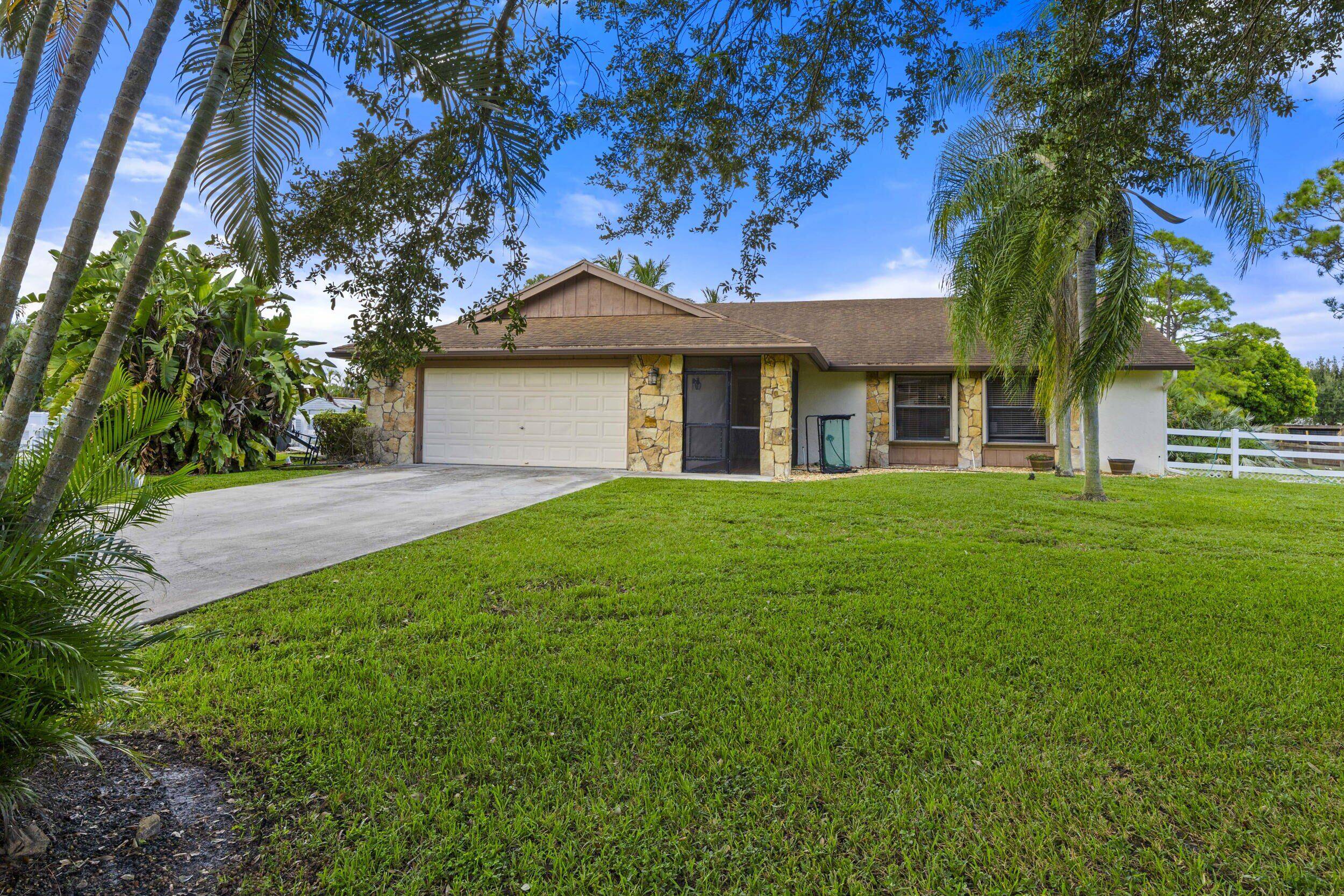 Beautiful ranch home located in sought after Palm Beach Ranchettes.