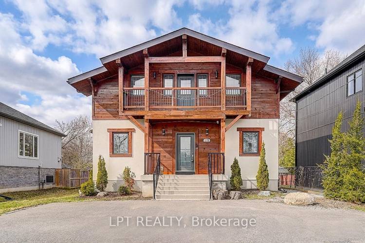 Indulge in the epitome of relaxing country living with this masterfully crafted custom estate, ideally situated just a short stroll from the sparkling shores of Lake Simcoe.