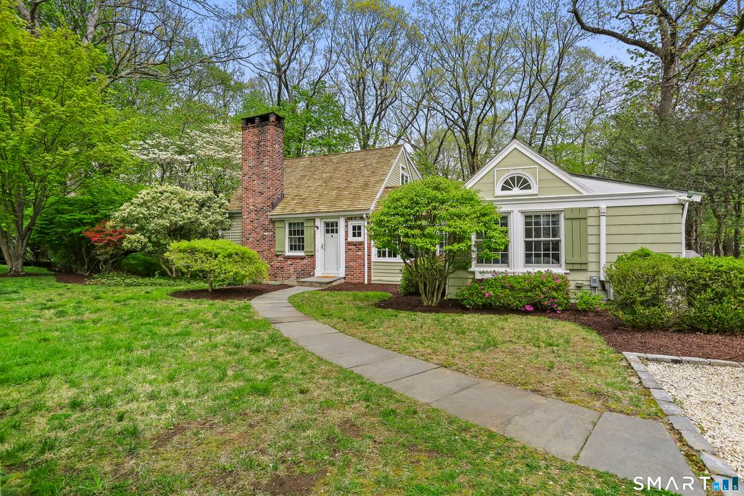 Fall in love with this immaculate and updated Storybook Charmer, nestled on half an acre in a special enclave near town and beach and train.