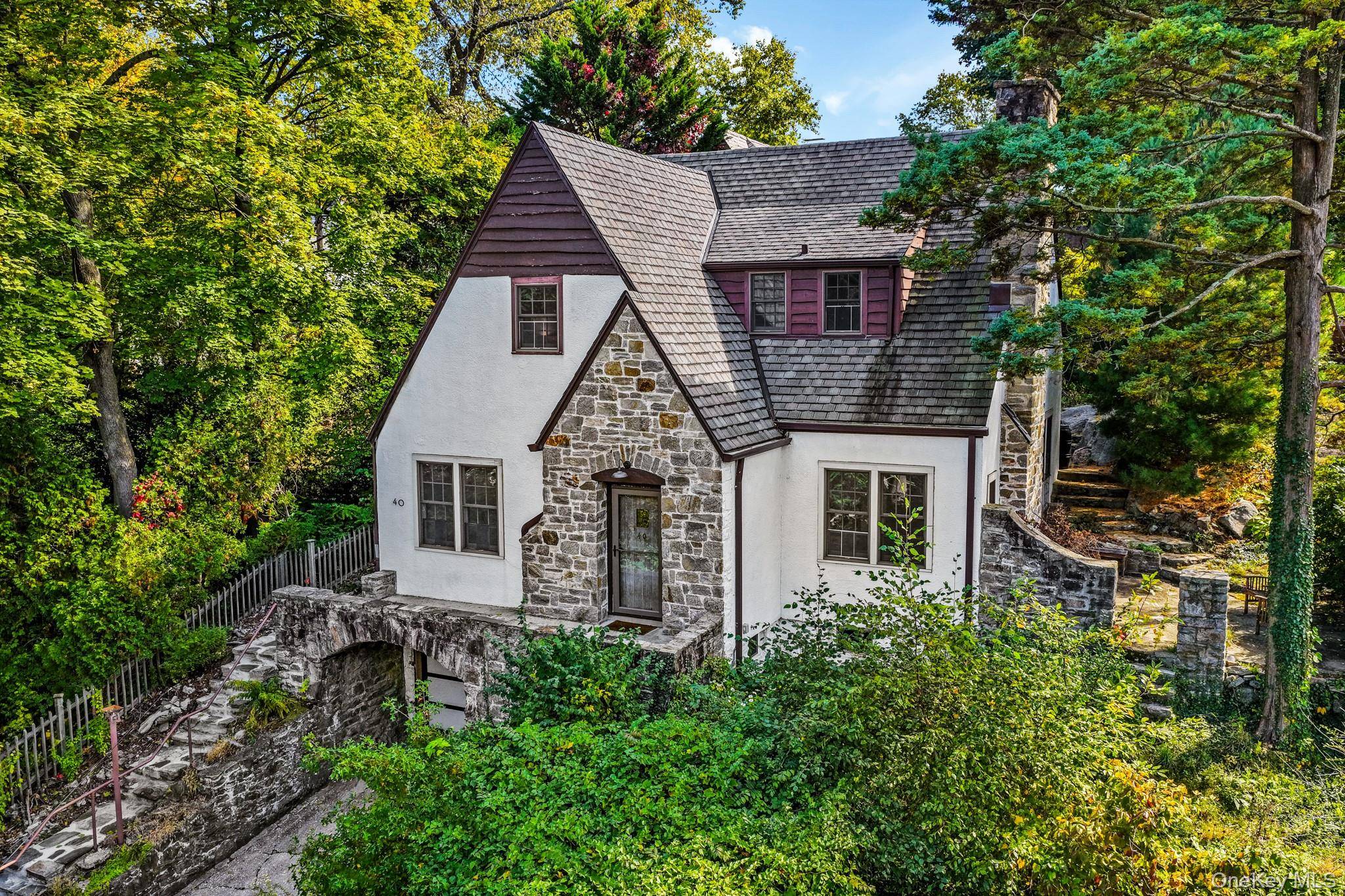 This storybook Tudor seamlessly blends old world craftsmanship with modern comfort in coveted Manor Woods.