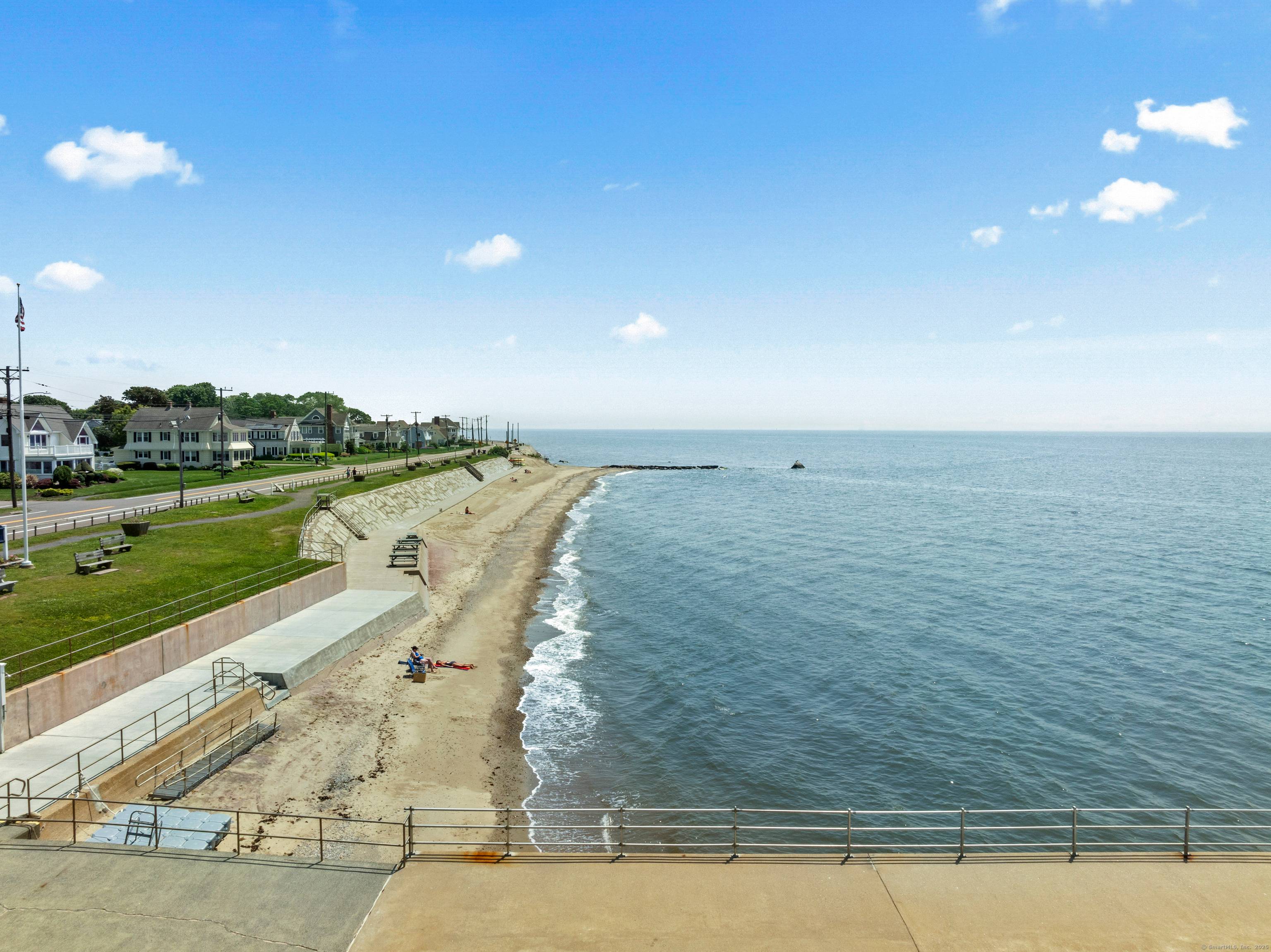 This spacious Knollwood Beach home is only ONE house from Long Island Sound featuring sweeping water views.