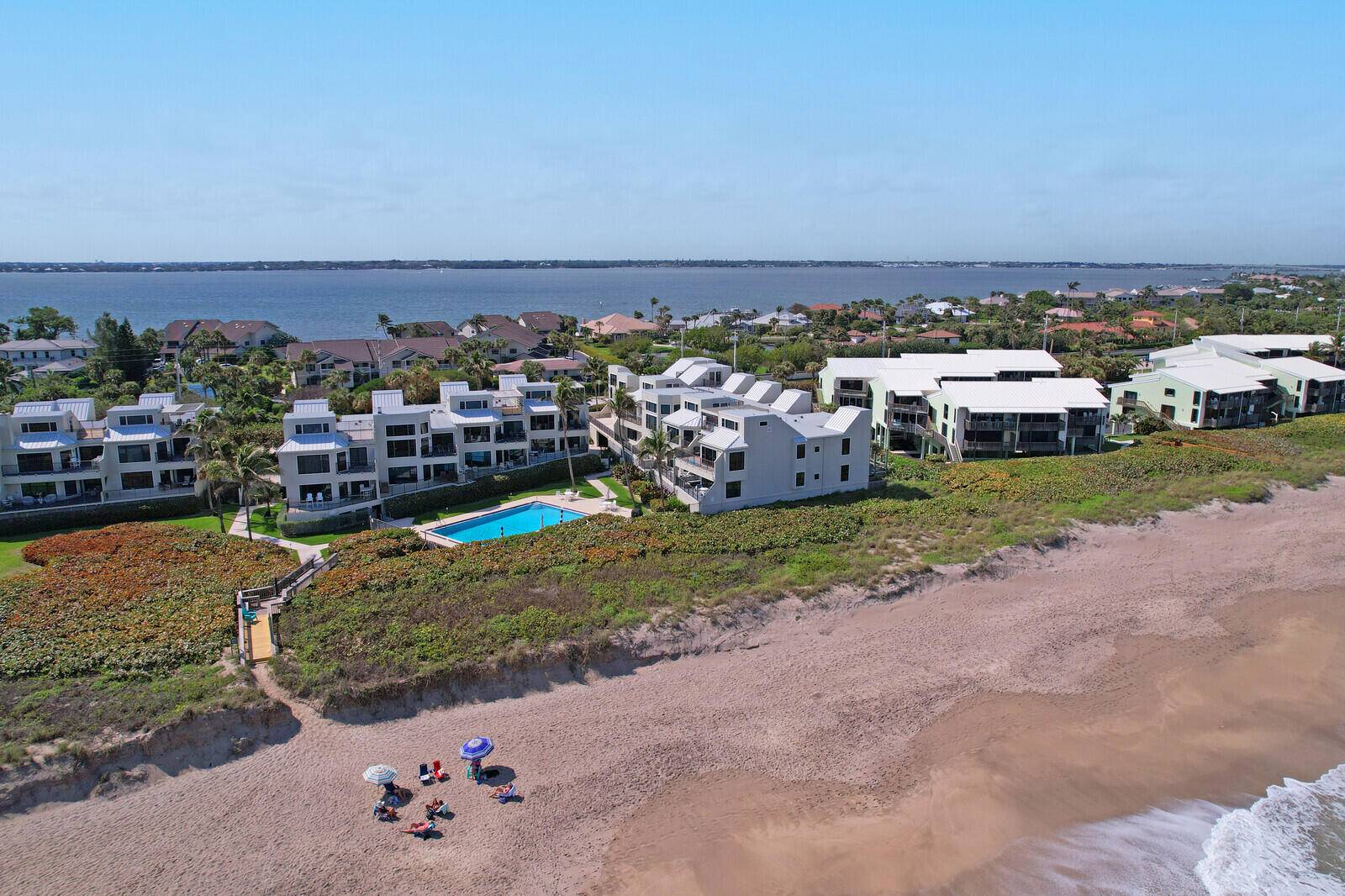 Wake up to breathtaking sunrises over the ocean and wind down with stunning sunsets over the river all from your private expansive rooftop deck, featuring new composite decking.