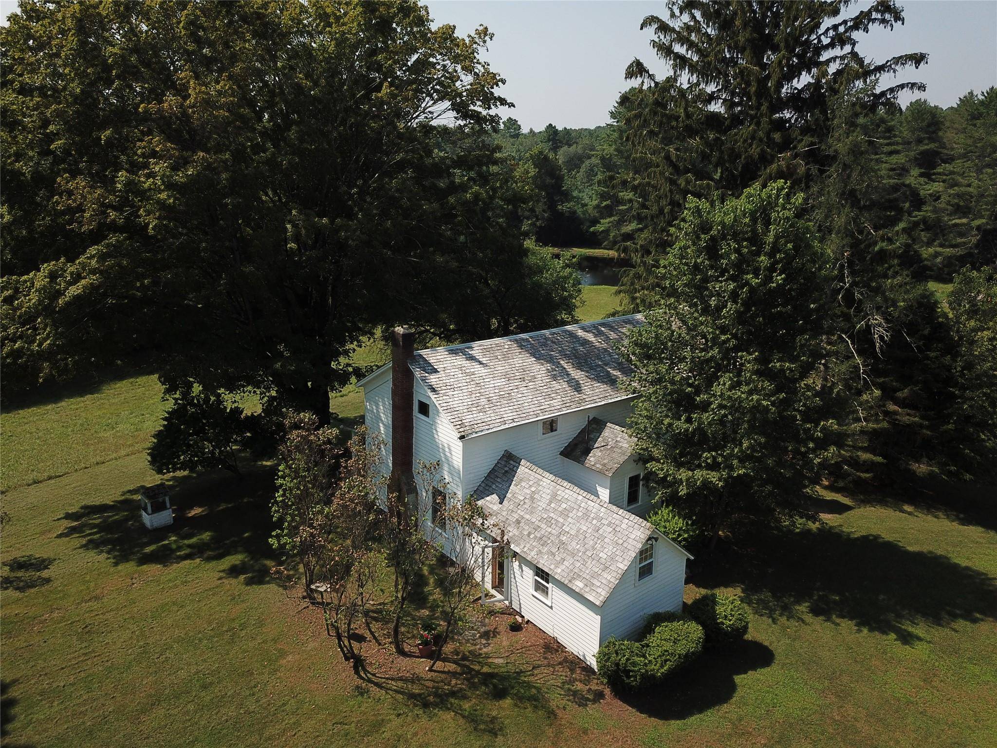 Wake up to 85 acres of green glory overlooking Lemon Brook Pond.