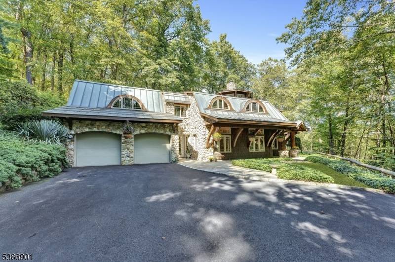 Experience refined living in this custom built estate nestled on a serene 2.