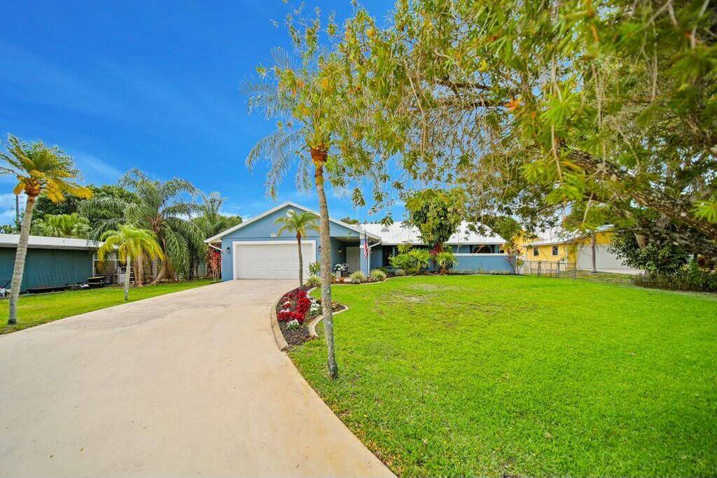 Welcome to your dream home in the heart of Palm City with NO HOA !