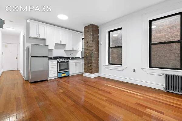 Spacious 2BD 1BA with renovated, eat In Kitchen, high ceilings, and hardwood floors.