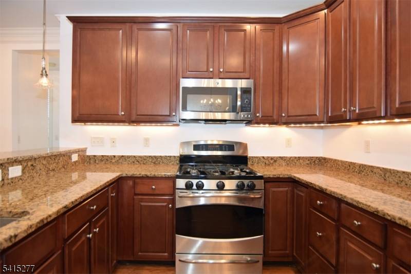 Private end unit with balcony, 2 bedrooms, office AND two 2 assigned indoor parking spaces with locked storage.