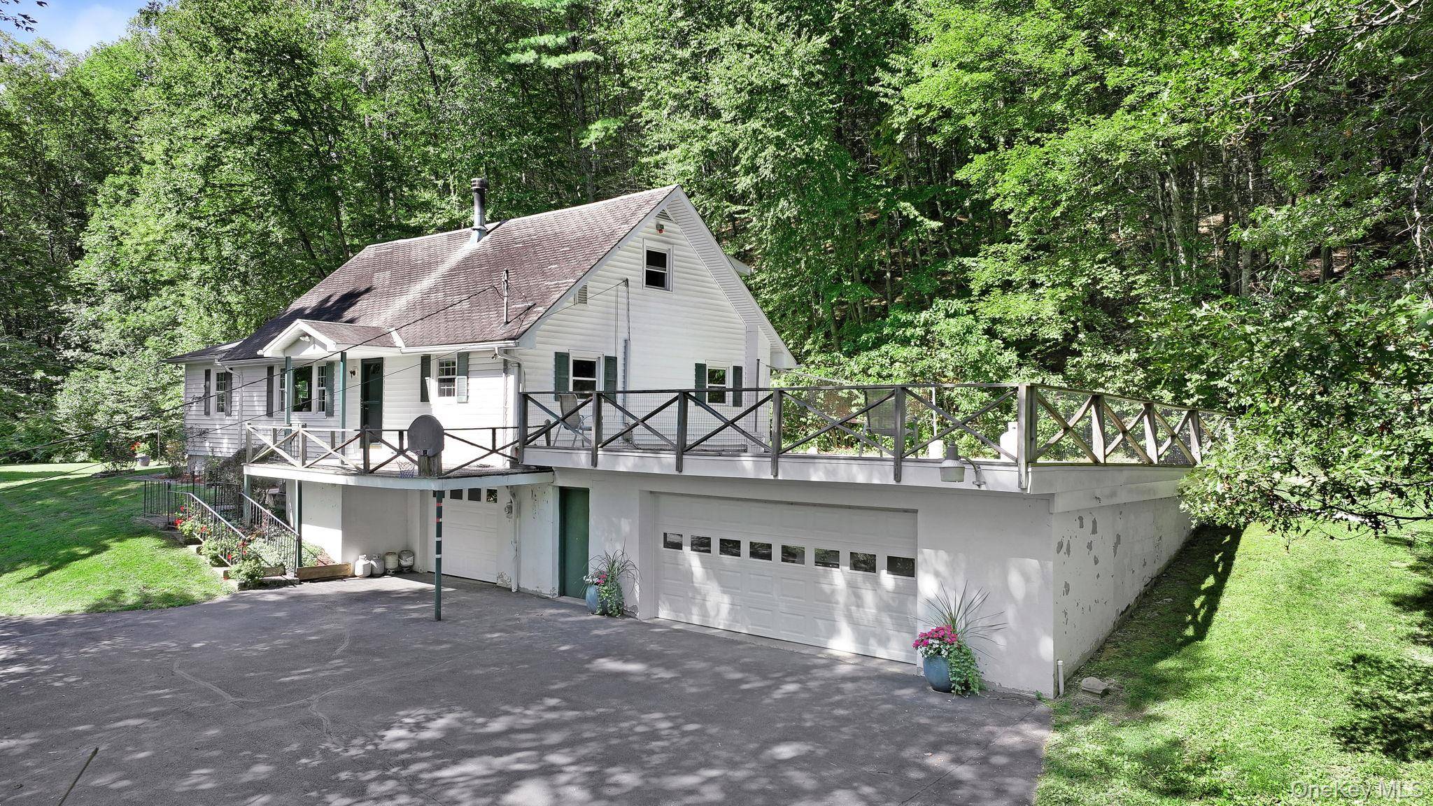 Perched on a knoll with lots of privacy from neighbors and the road is this well maintained Cape.