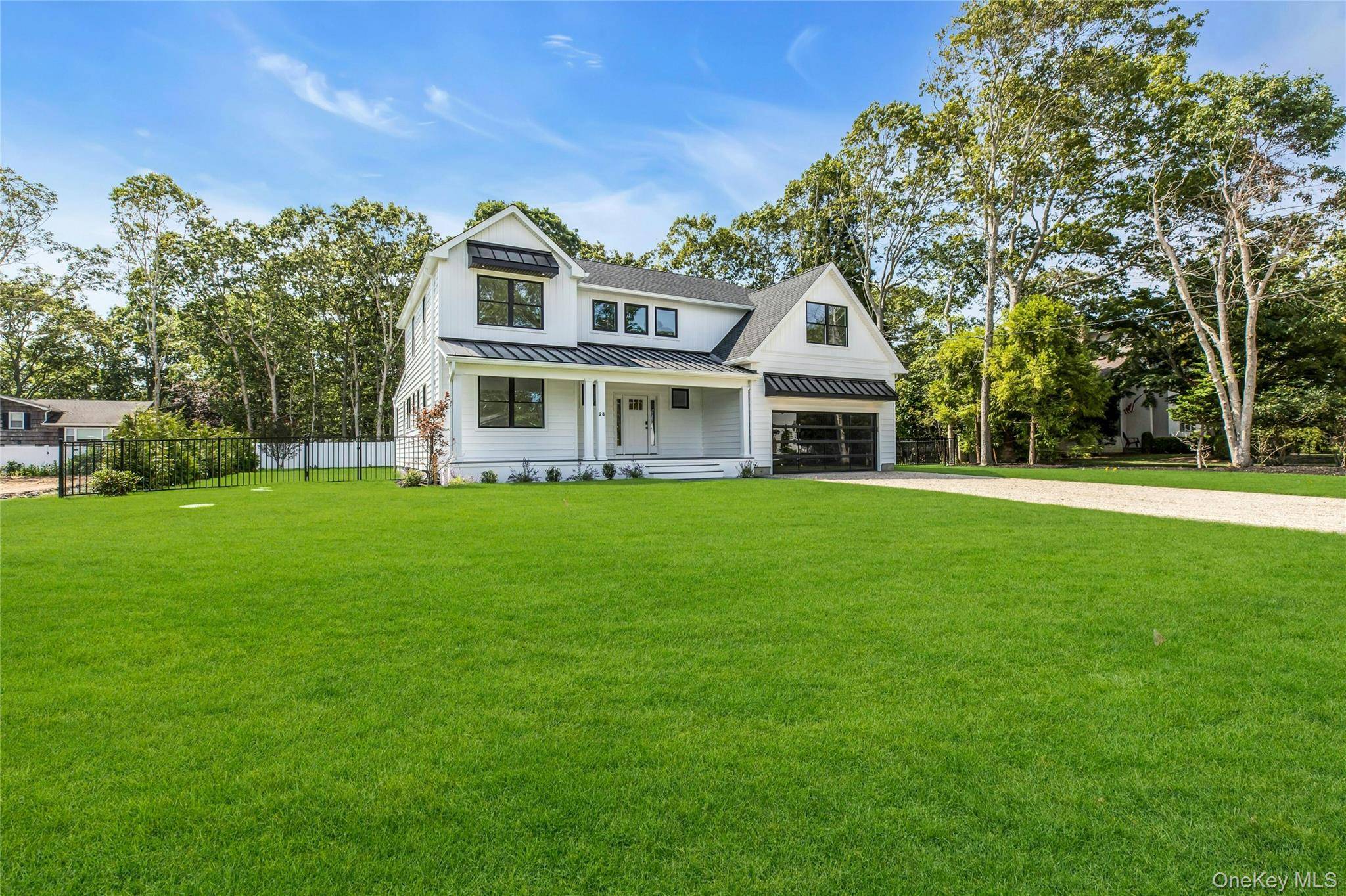 Welcome to your modern Hamptons retreat in the coveted Pine Neck community of East Quogue.