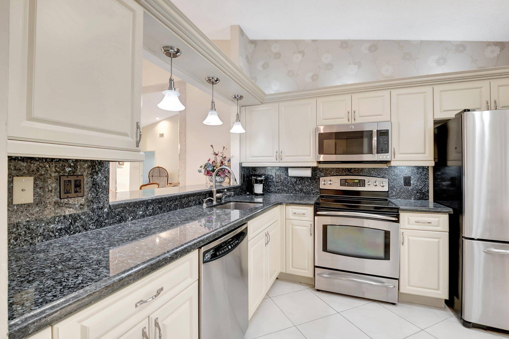 RARELY AVAILABLE Move Right In to this updated FULLY FURNISHED LAKEFRONT Villa in Desirable Palm Chase Lakes.