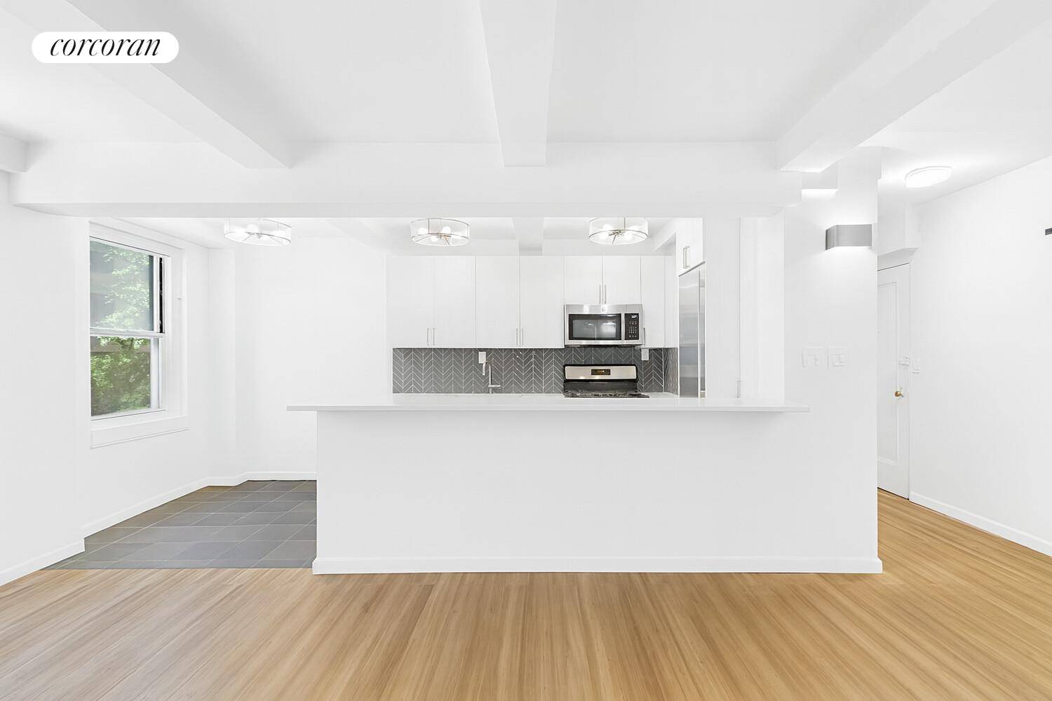 Stunning Corner Unit ! This home features a spacious living room and renovated kitchen with marble breakfast bar, Sub Zero refrigerator, and stainless steel appliance suite.