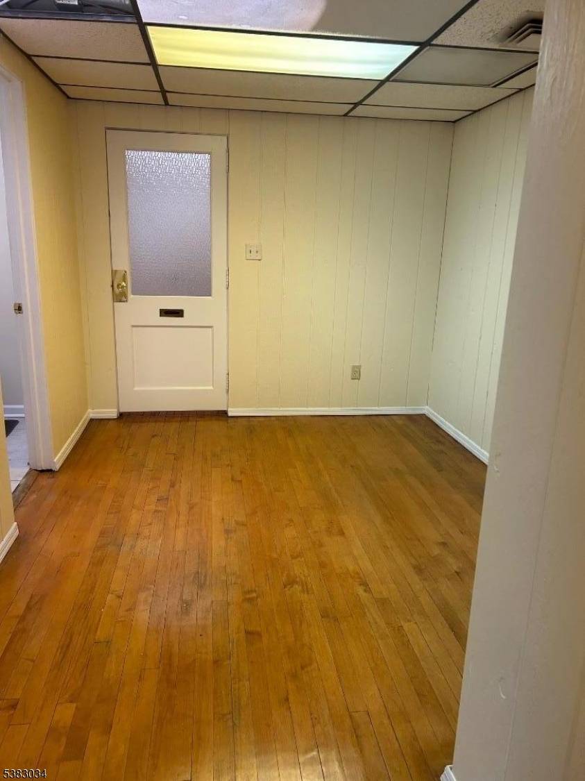 Approximately 425 sq ft of professional office space with large windows providing natural light, hardwood floors, and a private restroom.