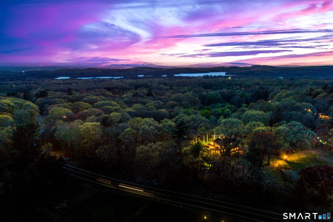 Tucked away on over 6 serene acres, this breathtaking retreat offers captivating western sunset views and a peaceful sense of escape.