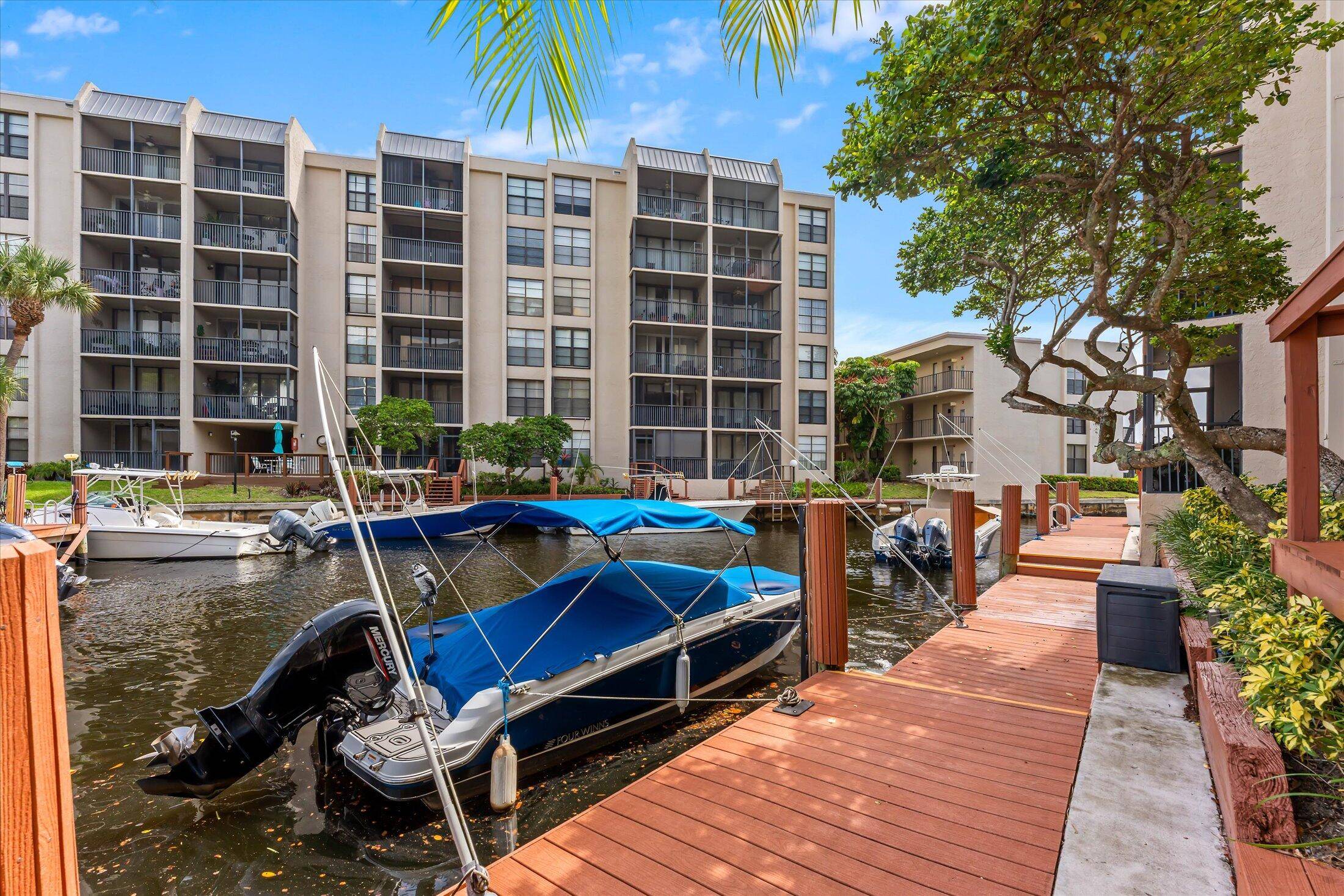 WATERFRONT FIRST FLOOR UNIT WITH DEEDED DOCK, NEW FLOORS 2024 A C RARE FIND IN BOCA BAYOU !