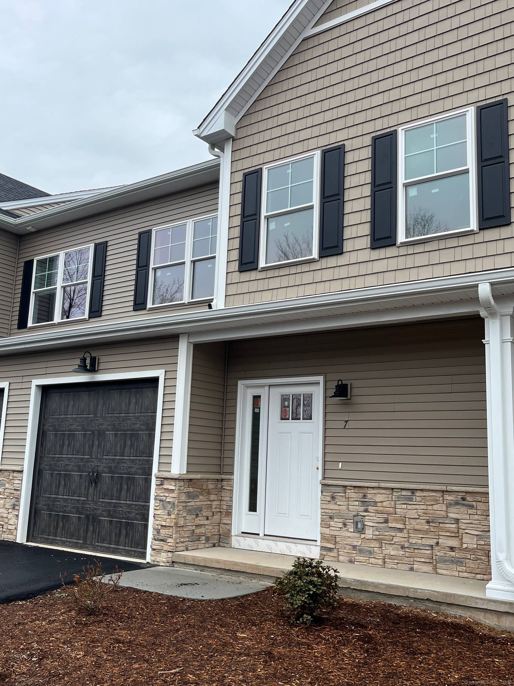 Welcome to this new construction townhome, with a bright and open floor plan that seamlessly connects the living room, kitchen, and dining area.