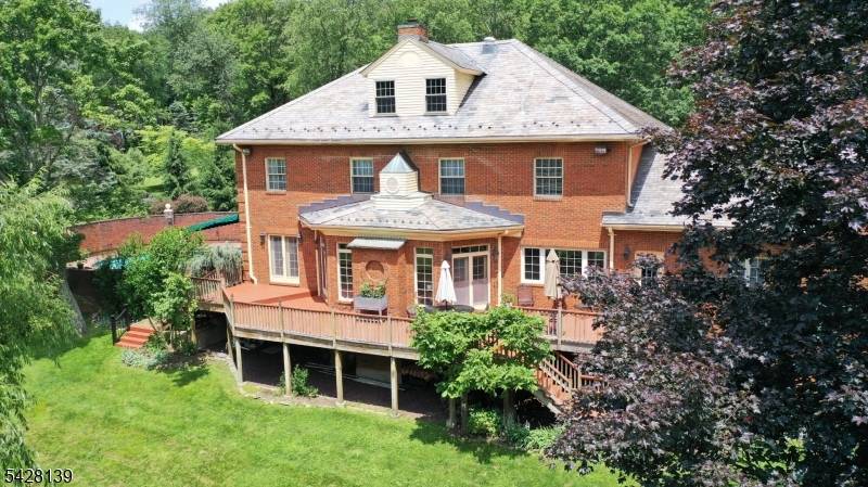 A Belgium block lined driveway welcomes you to this stately brick Colonial, meticulously maintained and thoughtfully designed to offer timeless elegance paired with modern updates, all set against breathtaking Long ...