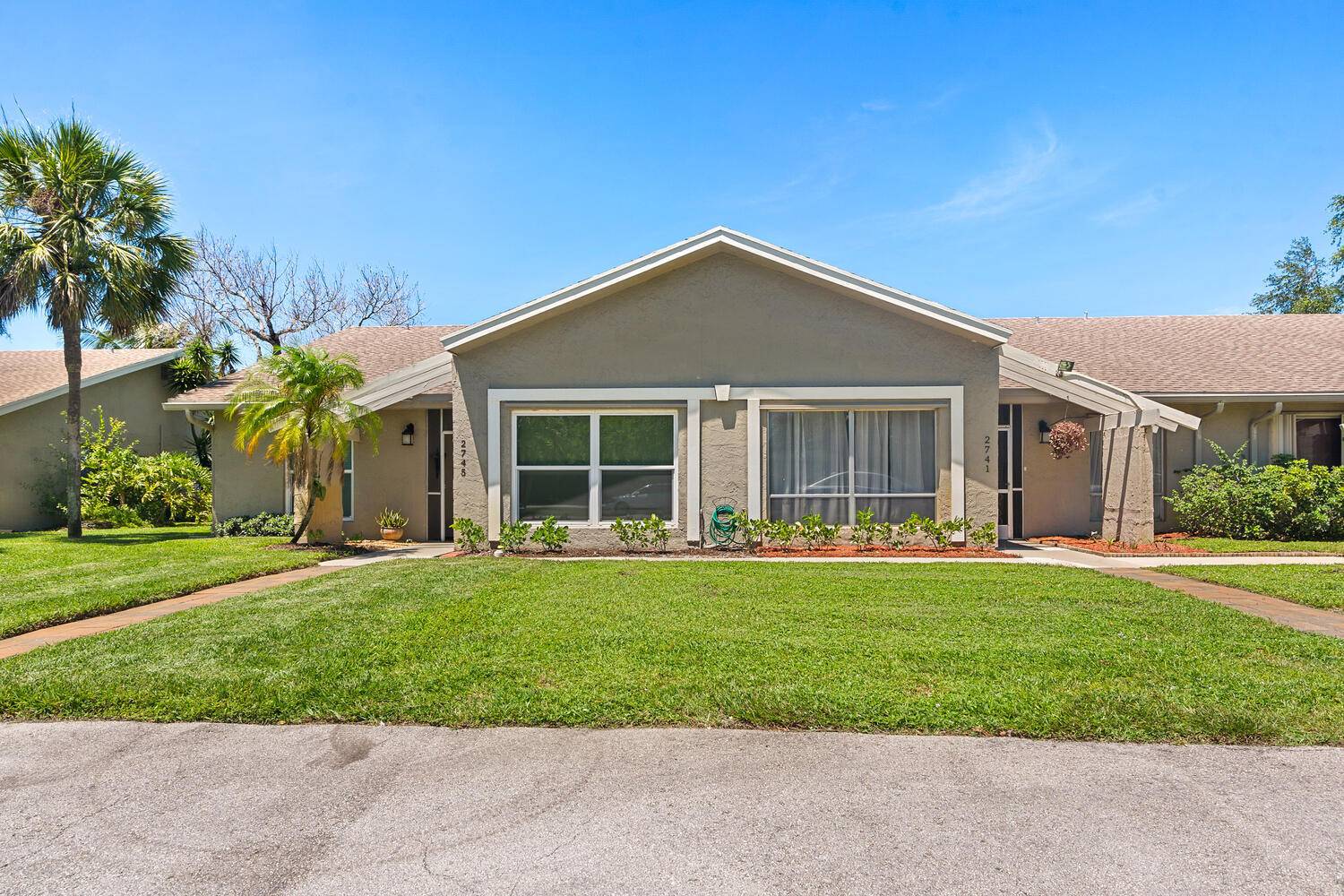 Tranquil Lake Views ! Spacious, Remodeled, 2 bedroom, 2 bathroom, waterfront attached Villa with enclosed Florida Room rear patio in Lago Del Rey of Delray Beach.