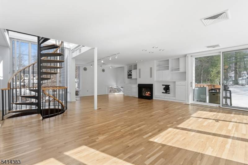 Expansive contemporary residence situated on a serene, wooded lot offering exceptional space, natural light, and a tranquil setting.