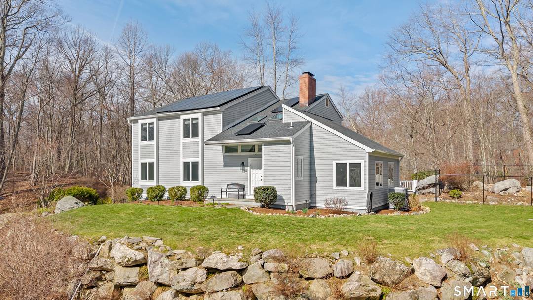 Set along a quiet private drive in North Stamford, this thoughtfully updated home offers a rare sense of calm, privacy, and effortless living.