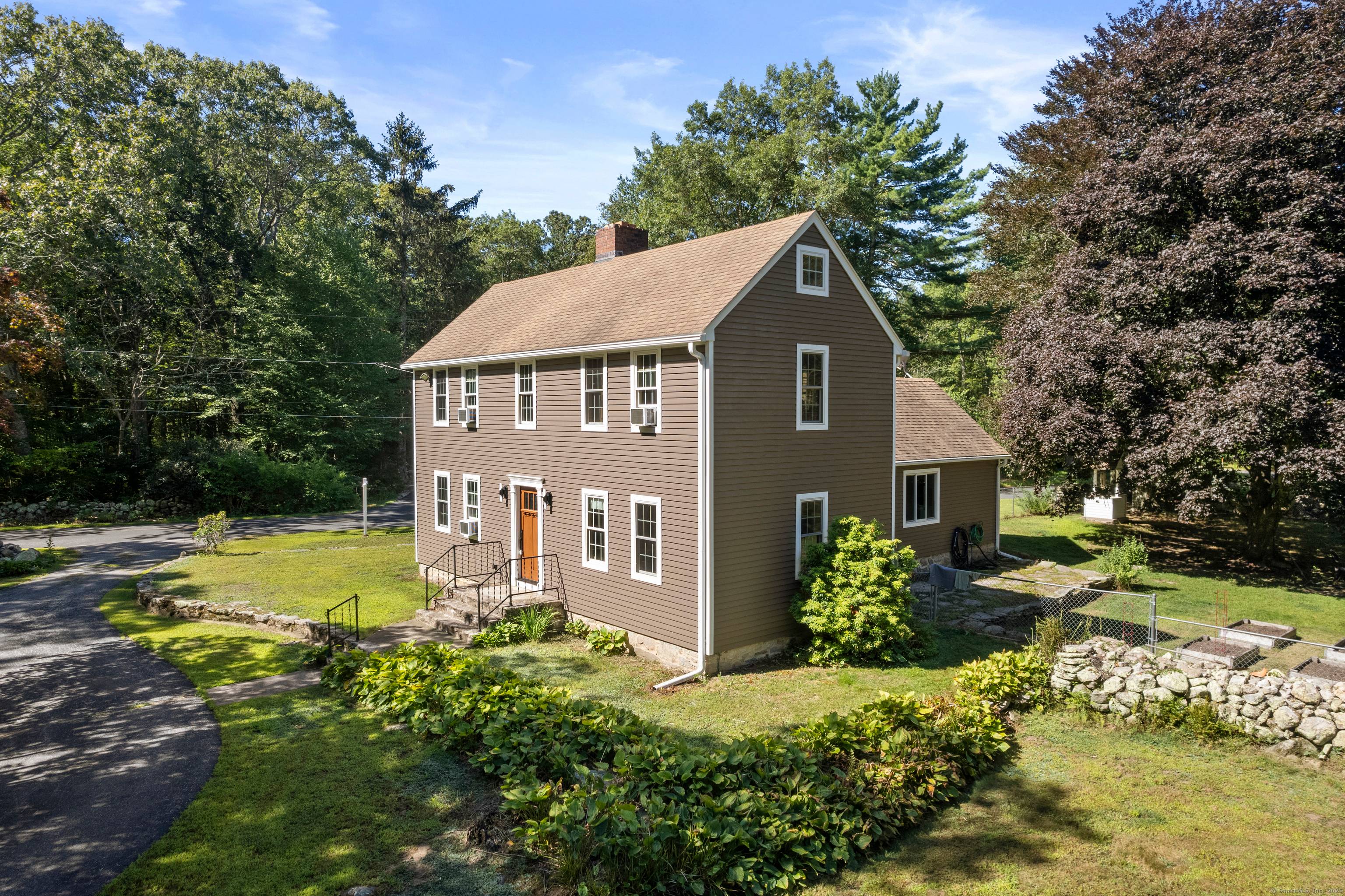 Country colonial with welcoming charm situated on almost 4 acres.