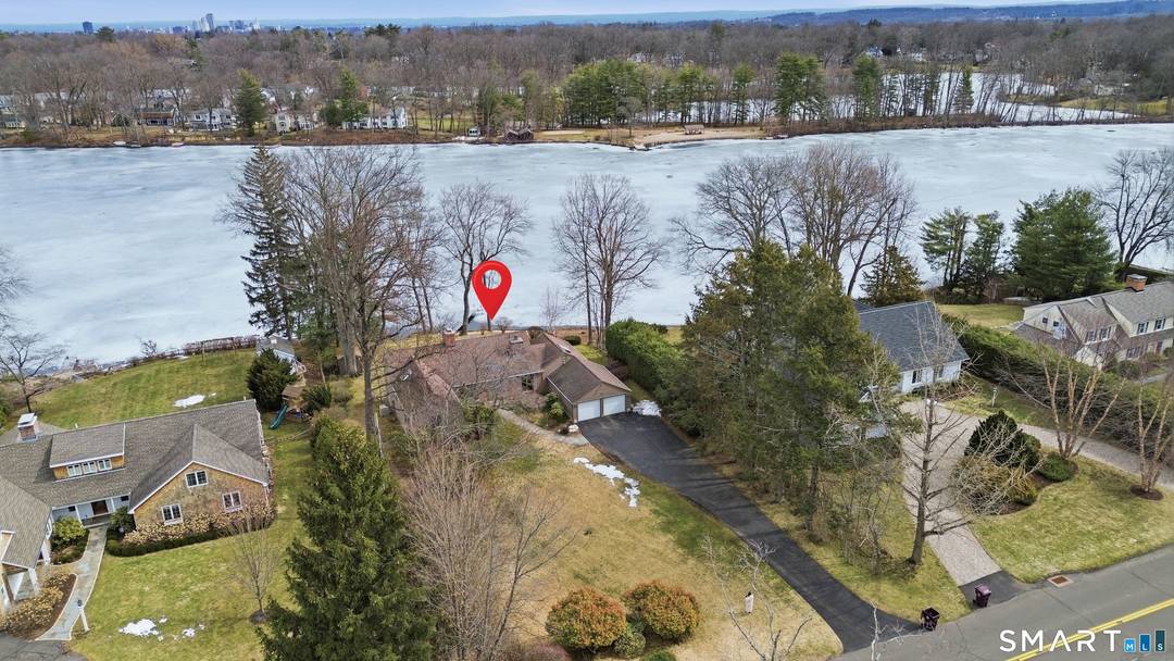 LOCATION, LOCATION ! Rarely available waterfront home on Woodpond in the desirable Farmington section, offering one floor living and endless potential to create your dream home.