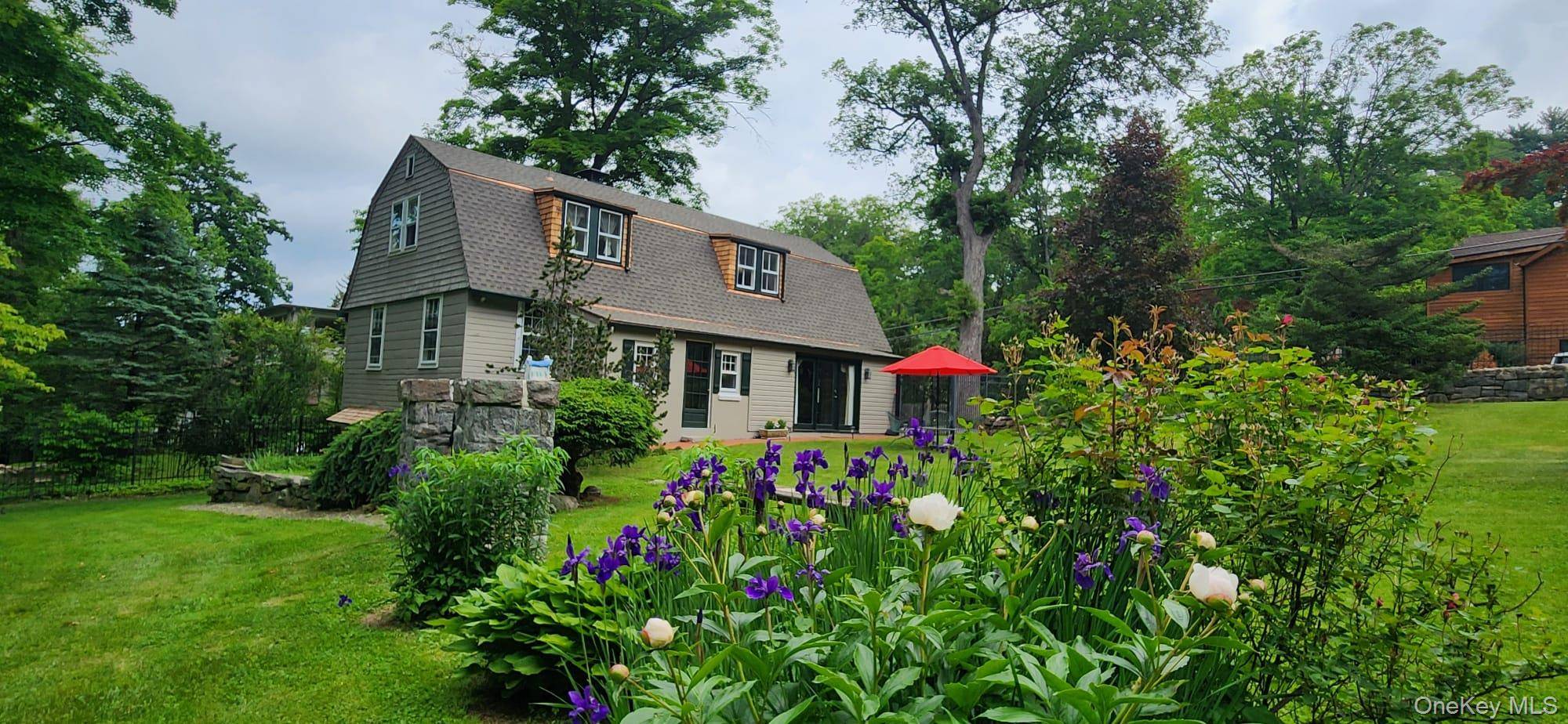 Nestled in the heart of gated, historic Tuxedo Park, this enchanting pre 1890 carriage house duplex unit on Clubhouse Road offers a perfect blend of timeless character and modern comfort.