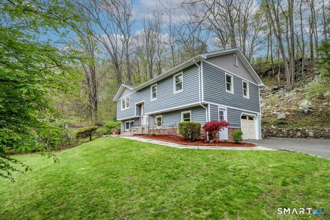 Welcome to 15 Wicks Manor in Danbury, a beautifully renovated raised ranch tucked into a quiet, peaceful neighborhood.