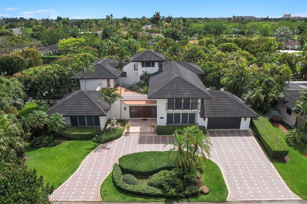 A home defined by space, light, and architectural character within the desirable enclave of Windemere Woode just off Sunset Drive.