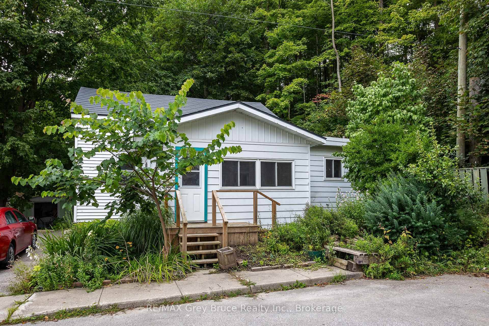 Discover the potential in this charming 2 bedroom, 1 bath home, nestled at the end of a quiet dead end street and tucked in against the escarpment.