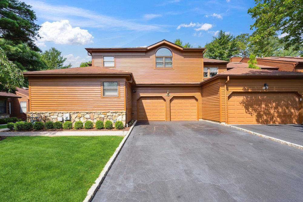 Welcome to 26 Hunt Ct, a rare offering in The Hunt Club, located within the prestigious Jericho School District.
