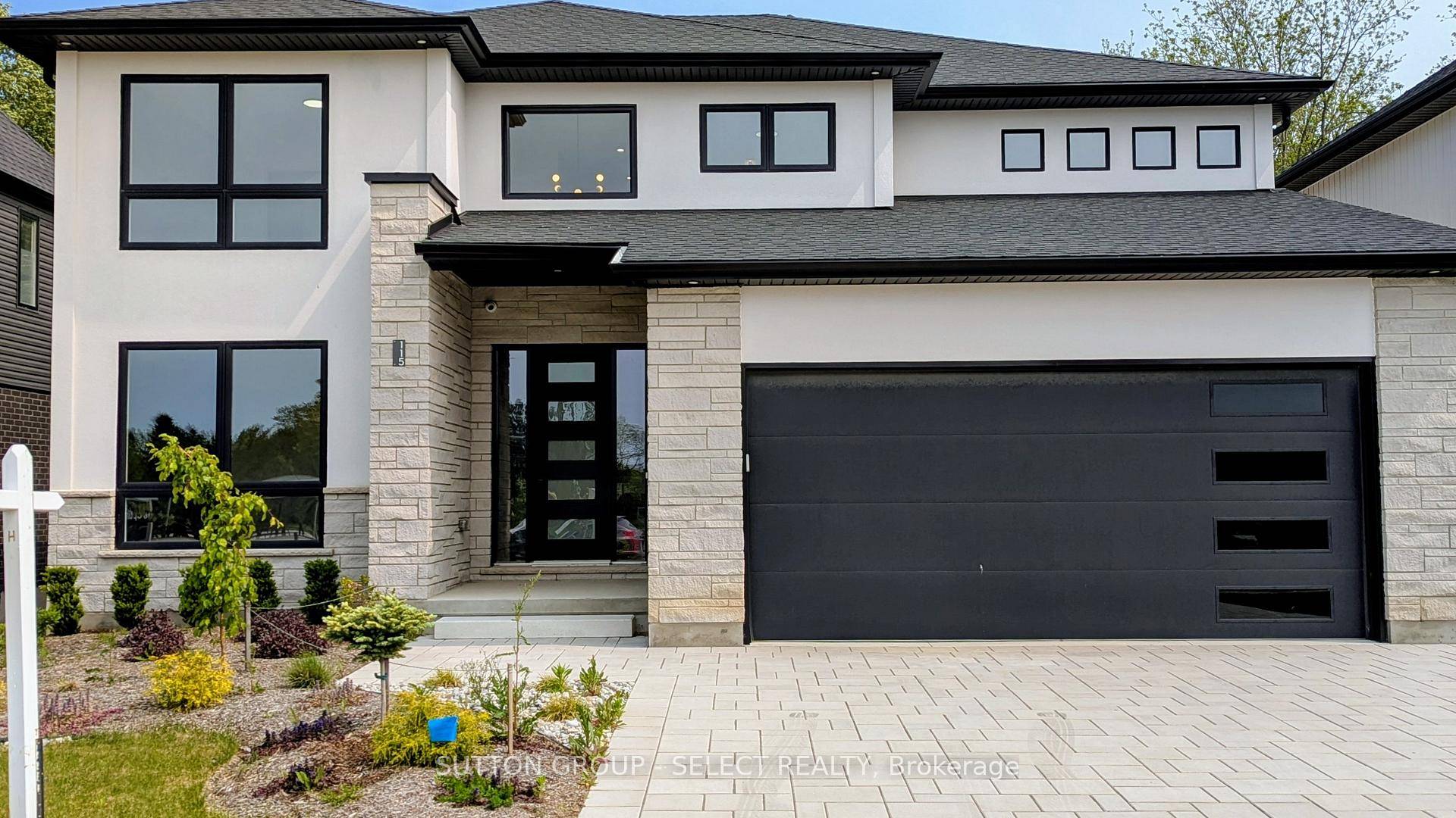This two storey executive home displays impressive curb appeal with natural stone, brick, and stucco combined with enlarged windows and front door with side lights, and a large covered outdoor ...