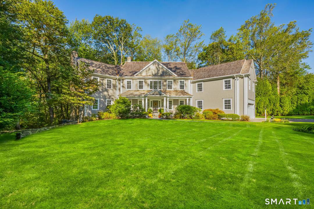 Tucked away on a quiet private cul de sac, 15 Waterbury Lane offers exceptional privacy on a beautiful one acre property in the heart of Darien.