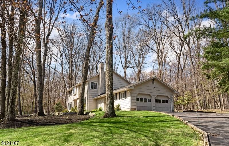 This warm and inviting center hall colonial home is located on a quiet tree lined street in the lovely Powder Mill North development section of Parsippany.