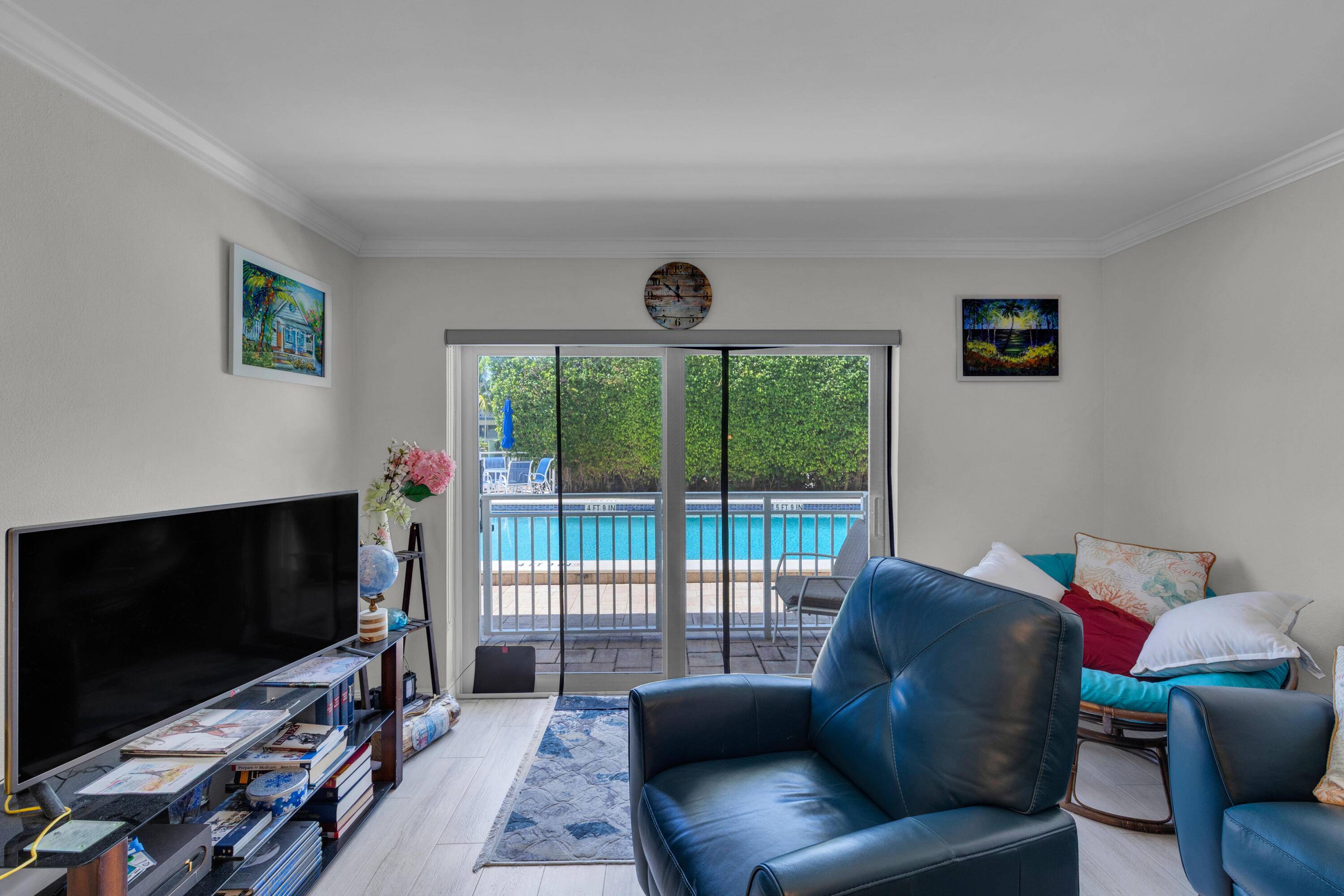 Corner ground floor unit with direct canal, boat, and pool views in a boutique building east of US 1.