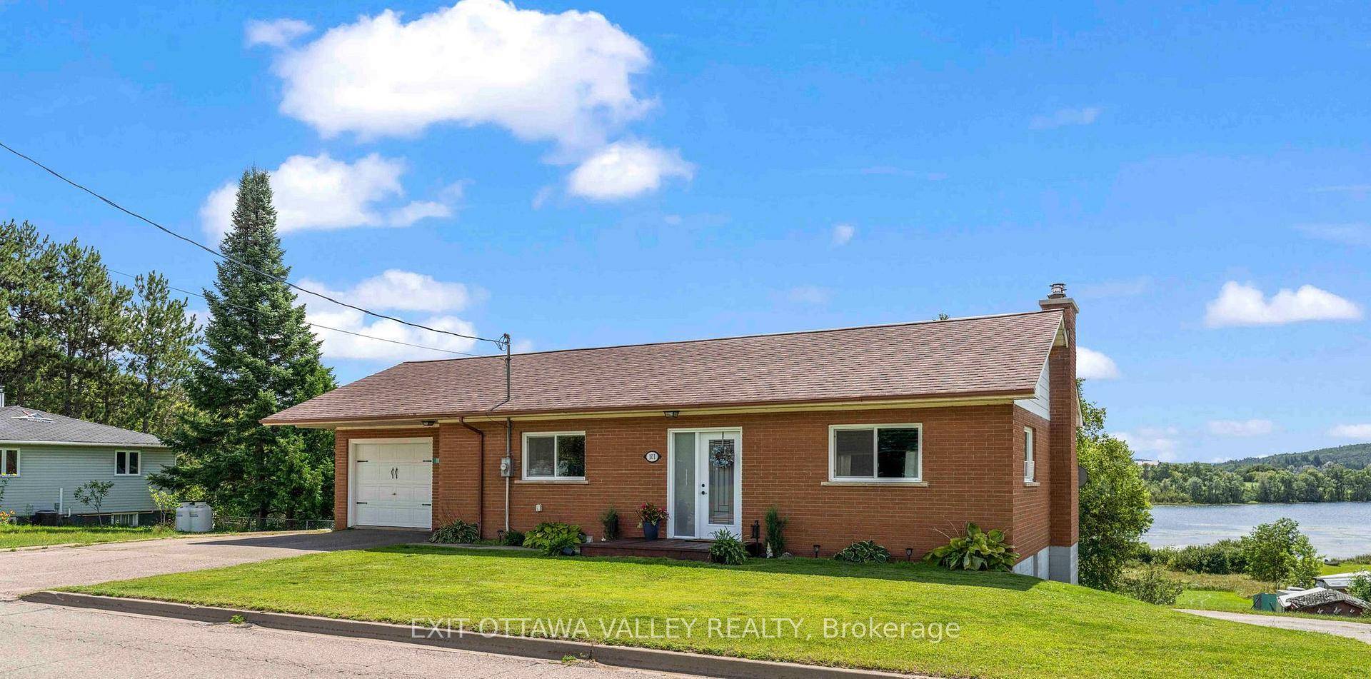 Discover the incredible potential of this solid brick bungalow, ideally situated on an ACRE of prime waterfront along the scenic shores of Kamaniskeg Lake.