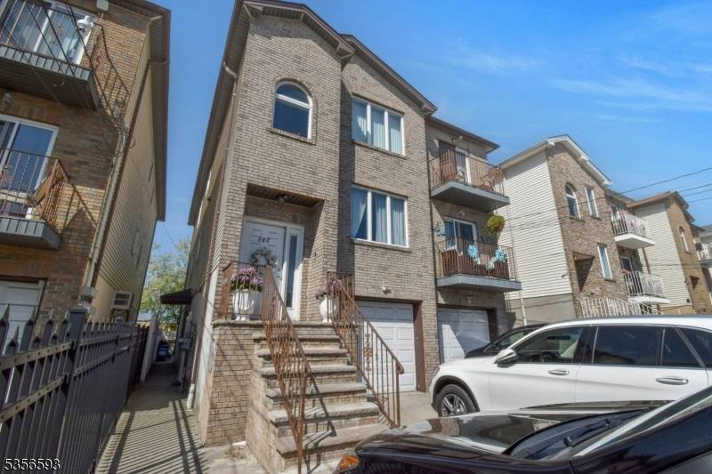 East facing 3 family spacious brick front home approx 27 years old, located in the Ironbound section with 2 car built in garage with additional parking for up to 4 ...